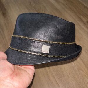 black leather fedora-style hat with a gold-tone zipper band The Hatter box L